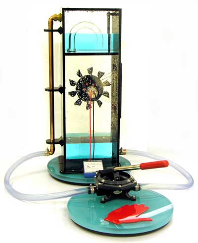 This is one of our new designs. Use the red lever to pump the water up into the upper tank. Once it reaches a certain level it will automatically siphon down onto the turbine wheel. As the wheel turns it powers the generator which is connected to a milliammeter.