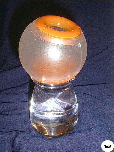 Concept light.  Base was machined from solid acrylic and polished. The diffuser was fabricated from acrylic sheet heat formed and frosted. Orange doughnut heat formed and spray painted.